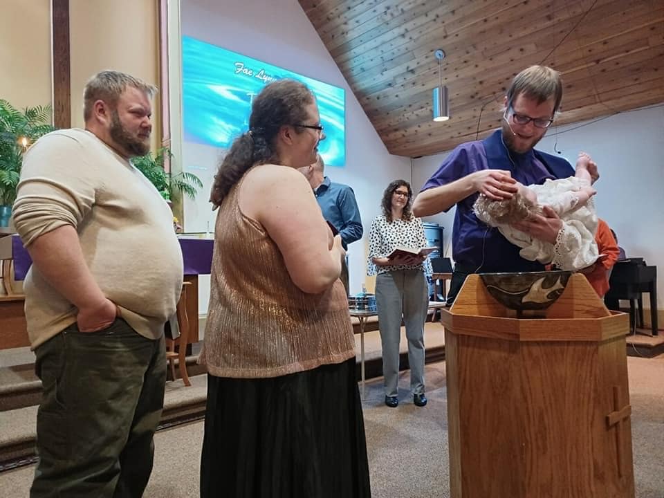 Baptism of a young child during service.