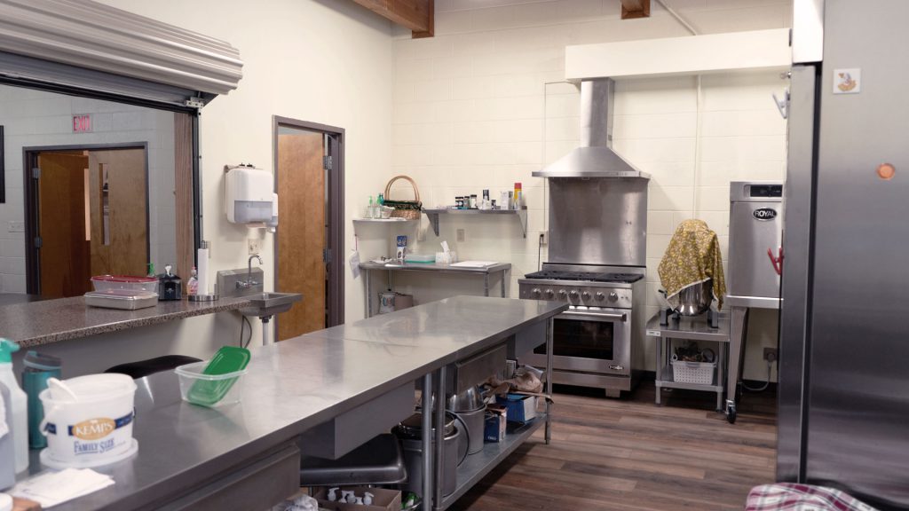 Fellowship Hall kitchen with stainless steel counter and stove.