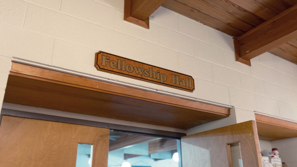 Fellowship Hall entry way sign above door.